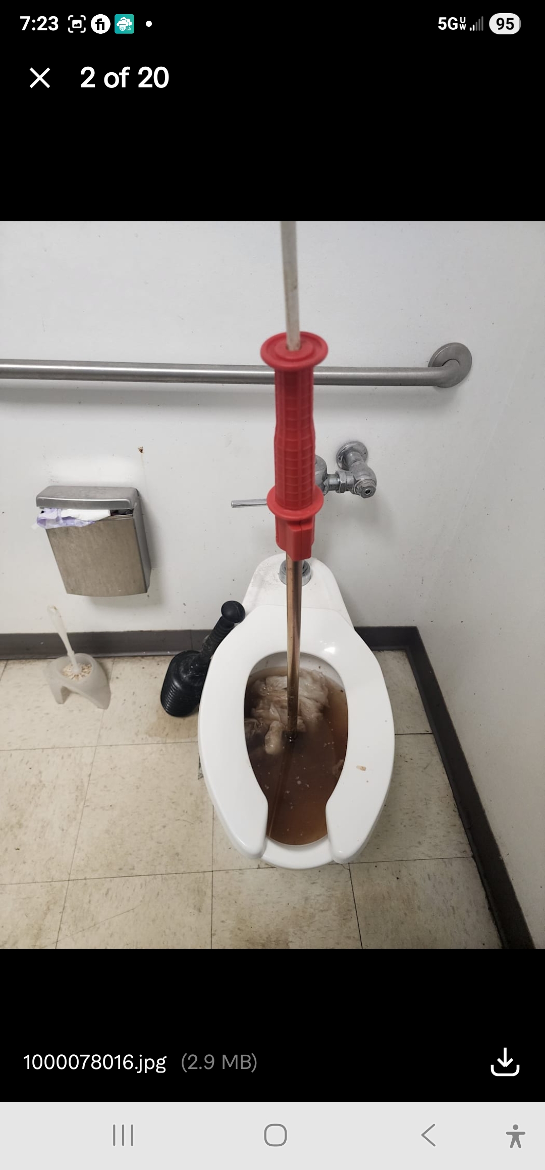 Plumber snaking clogged commercial toilet drain in Pittsburgh