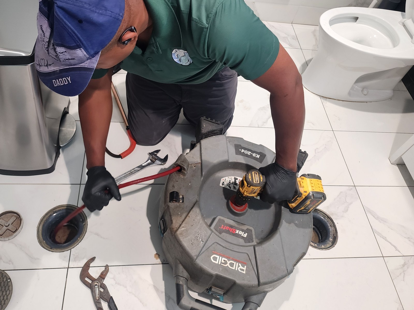 Day to Day Plumbing technician clearing a clogged drain with a RIDGID drain cleaning machine in Pittsburgh PA