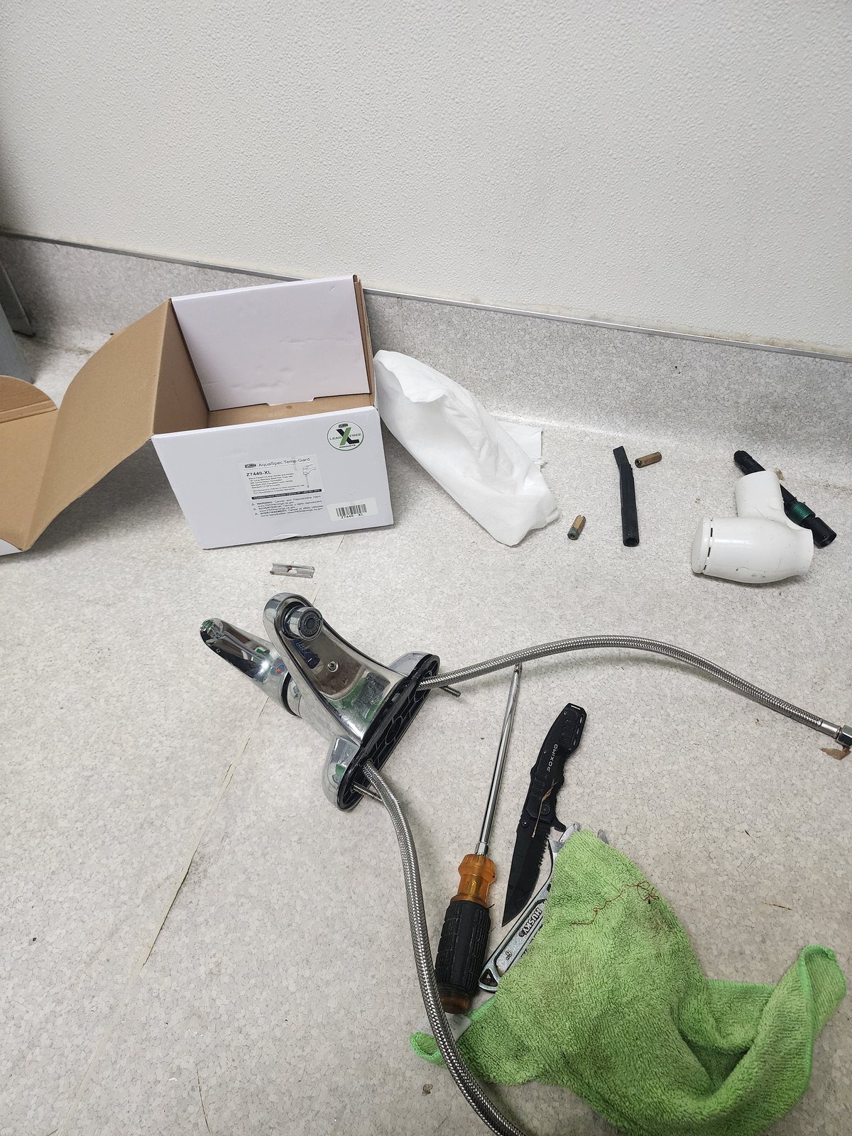 Commercial faucet and tools staged before installation