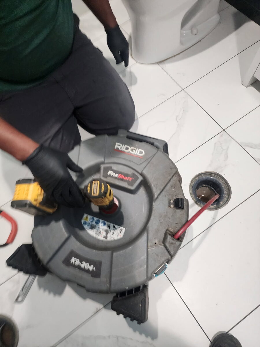 Drain machine cable running into a floor drain