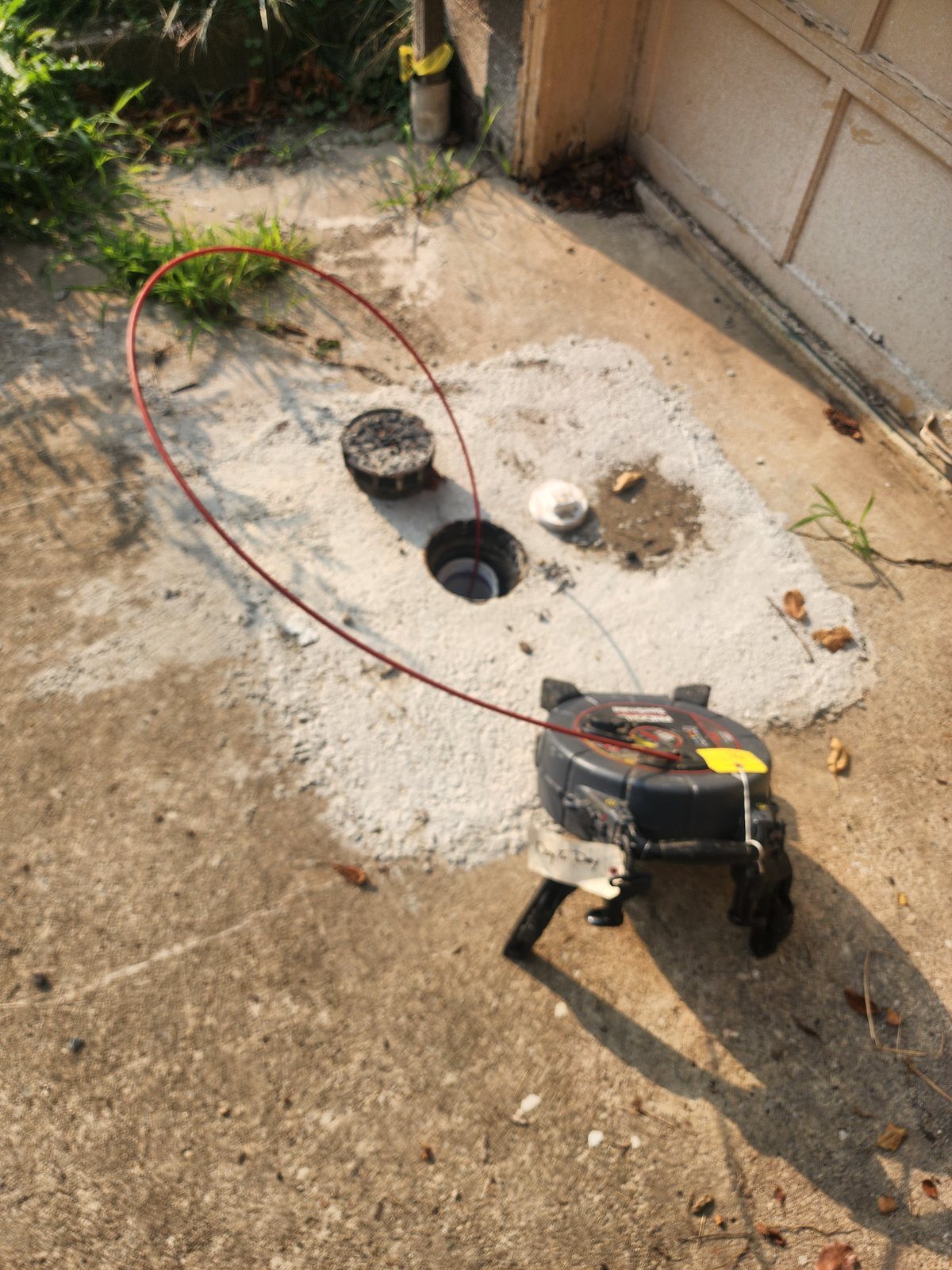 Clearing a blocked line through an outdoor cleanout outside a commercial building