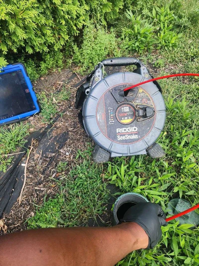 RIDGID SeeSnake camera going into an outdoor cleanout
