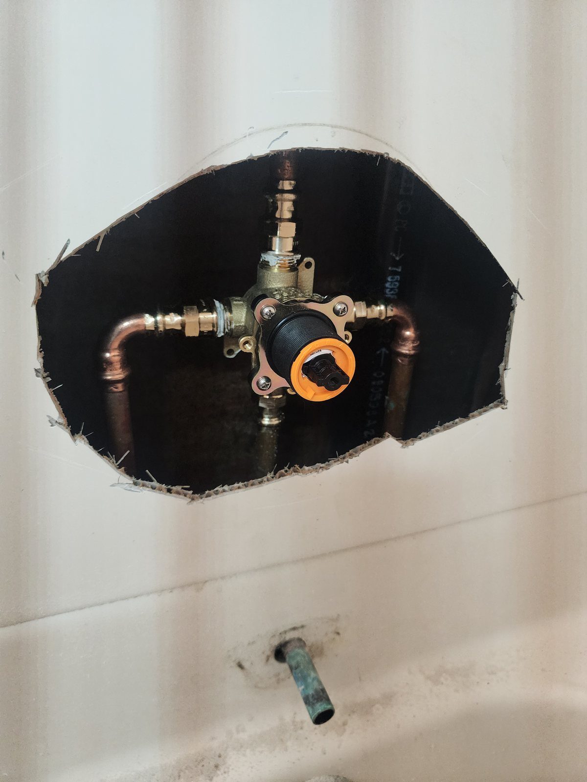 Shower valve replacement through an access opening showing copper and PEX supply lines