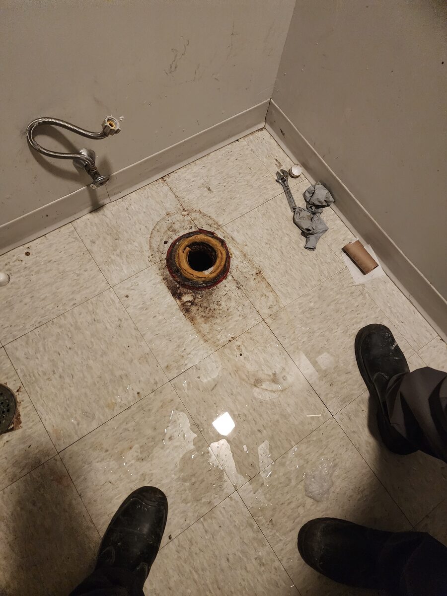 Toilet flange exposed for repair