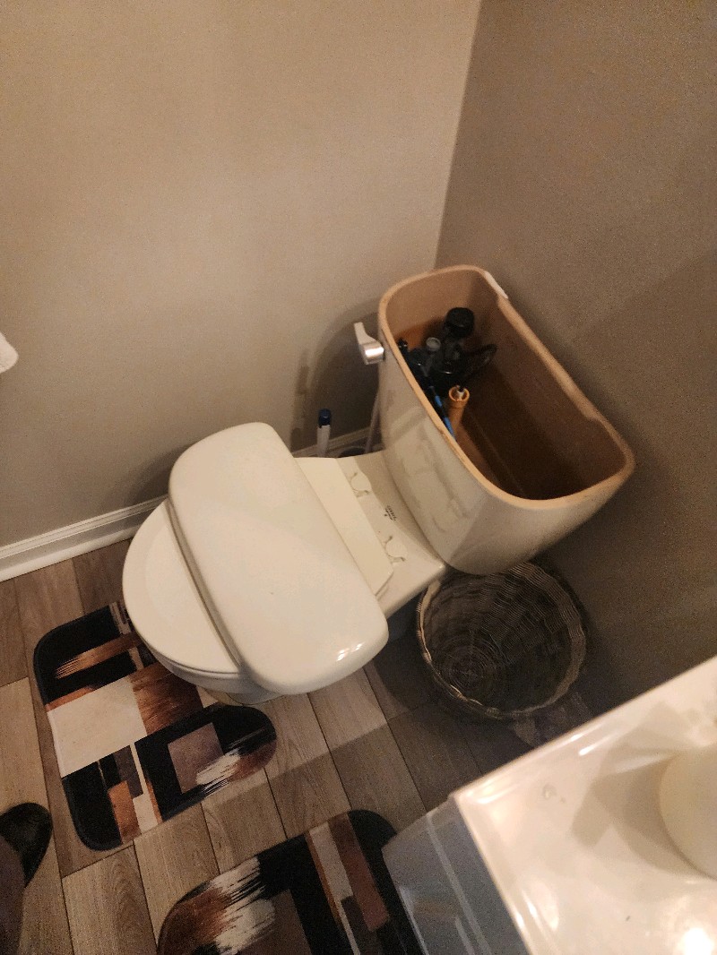Toilet tank removed open showing internal mechanism for repair Pittsburgh PA